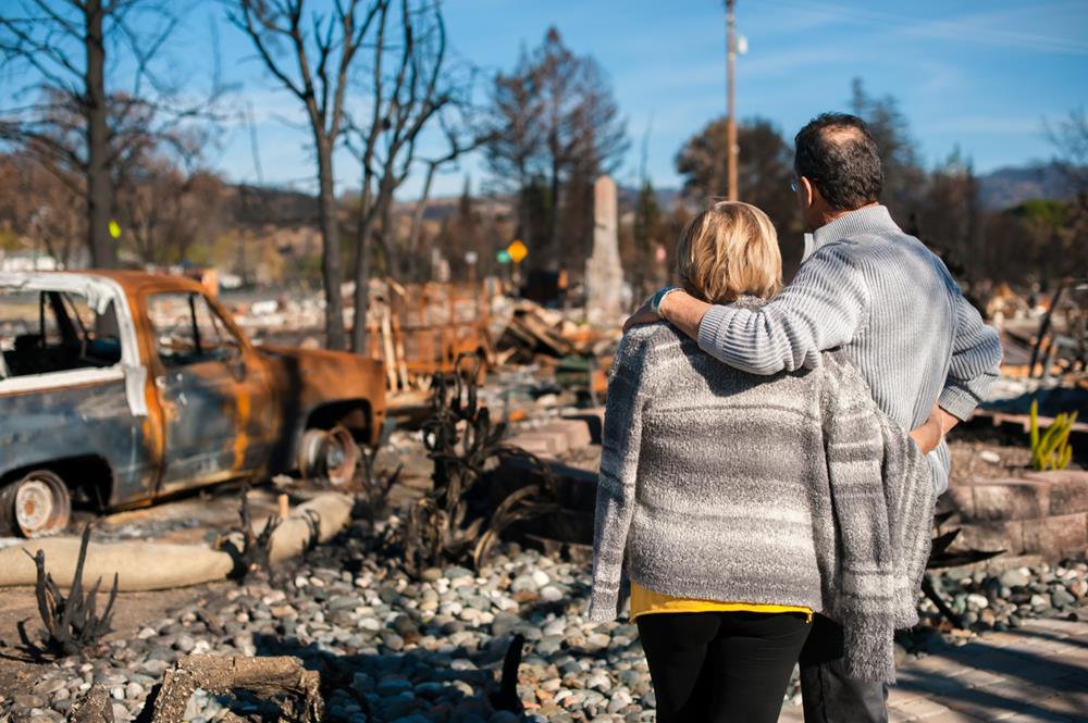 Couple checking the damage caused by wildfire