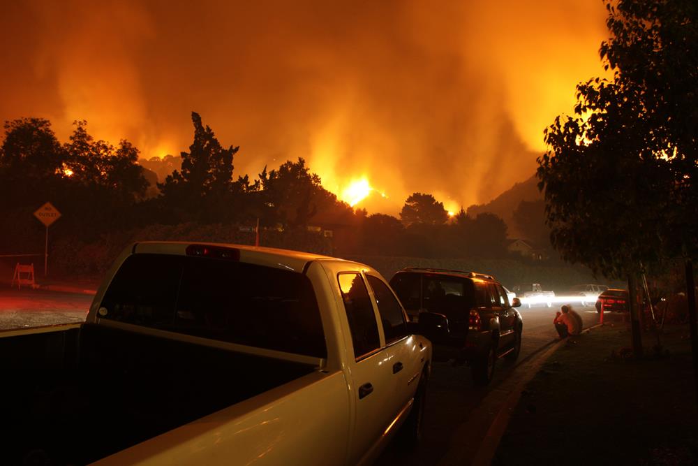 Neighborhood sit by and watch a fire threaten their homes