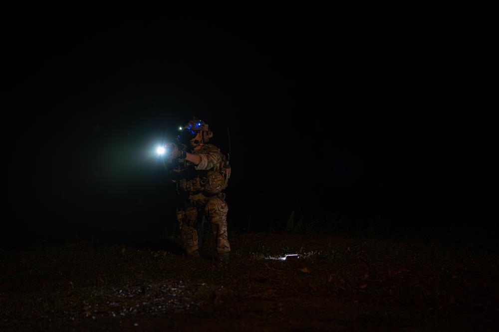 A soldier using a flashlight
