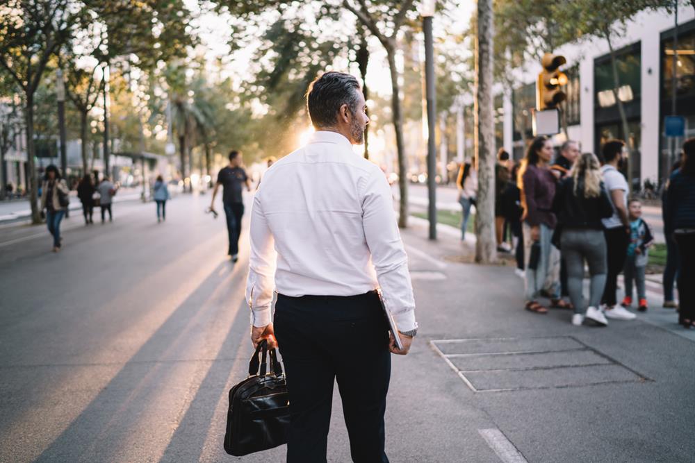 Man in an office attire walking outside