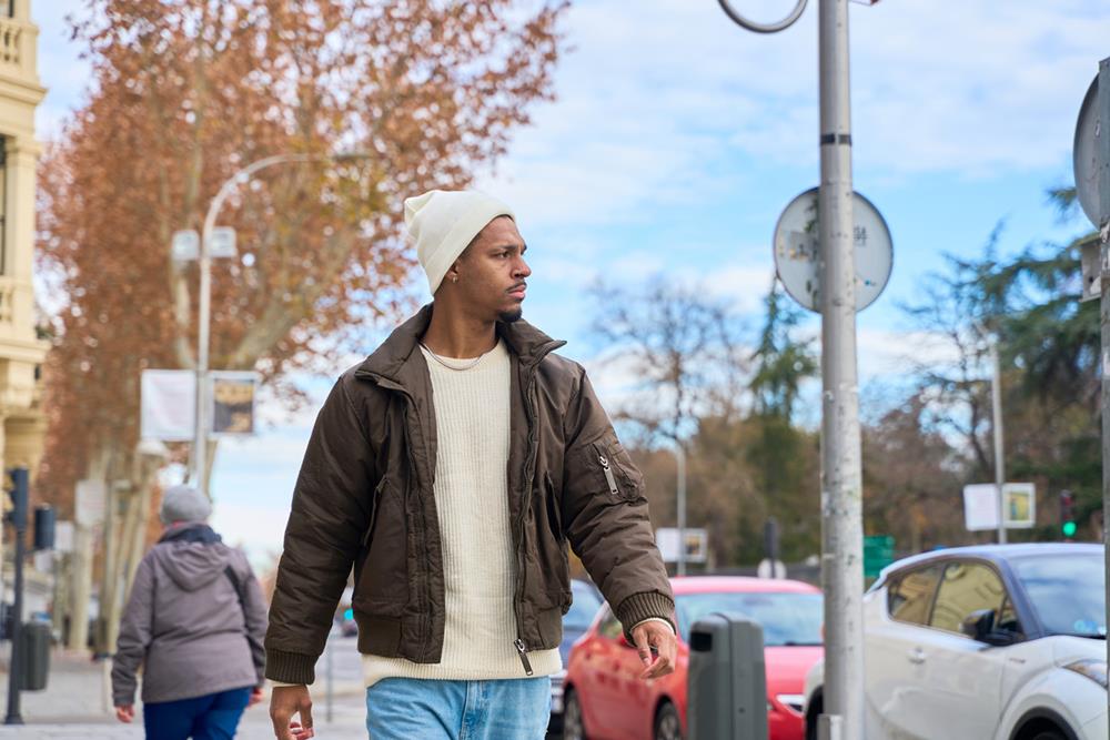 Man walking confidently down an urban street