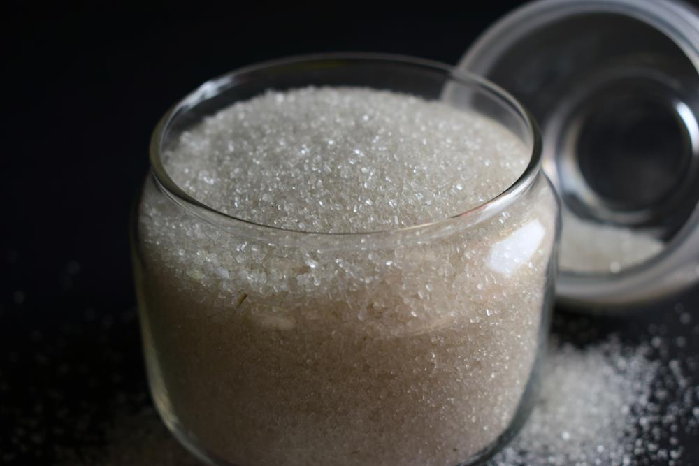 Sugar in transparent glass jar