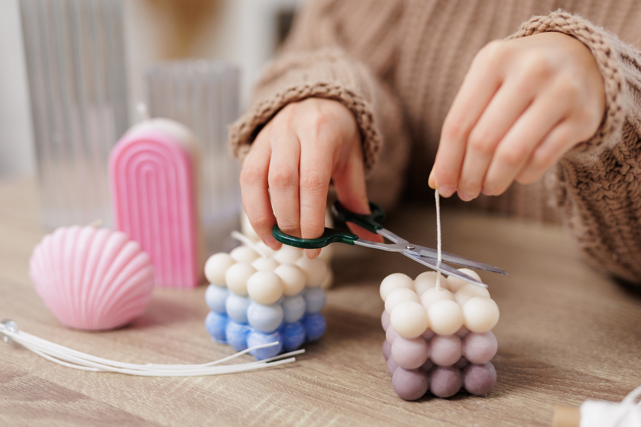 Woman cutting the candle wick