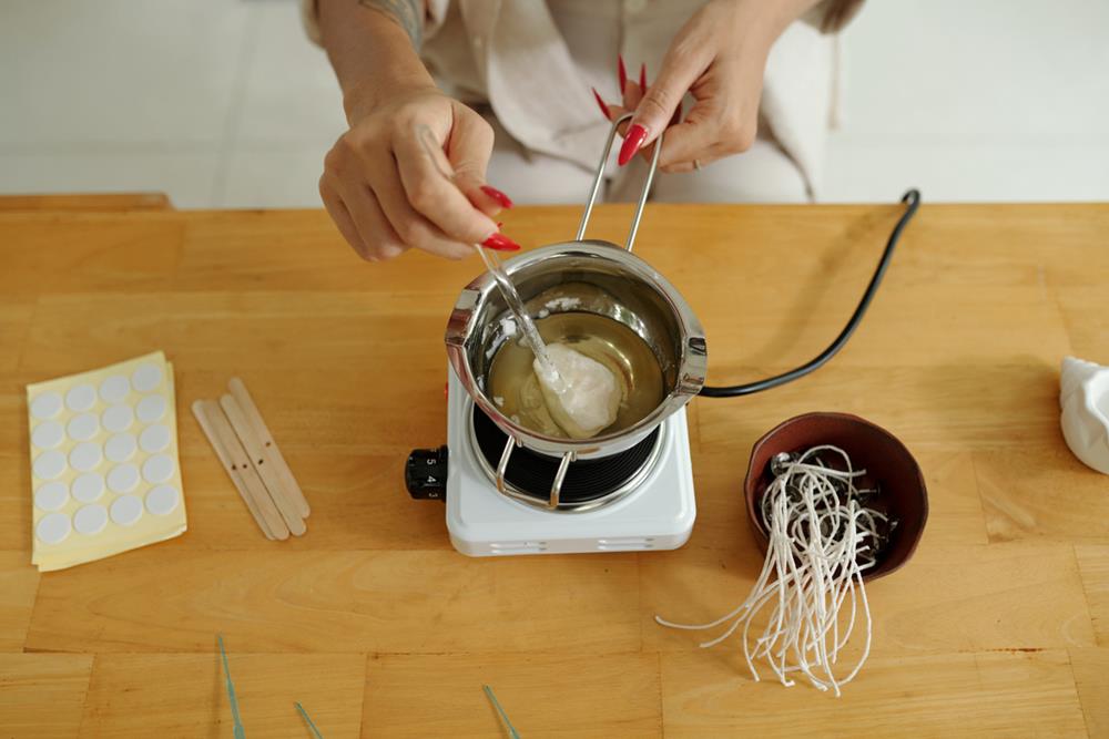 Woman melting candle wax