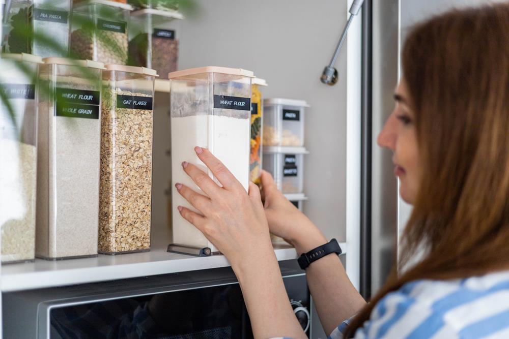 Woman organizing food storage in the kitchen