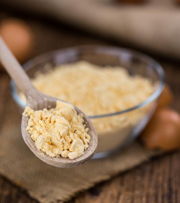 Fresh powdered egg on a wooden spoon