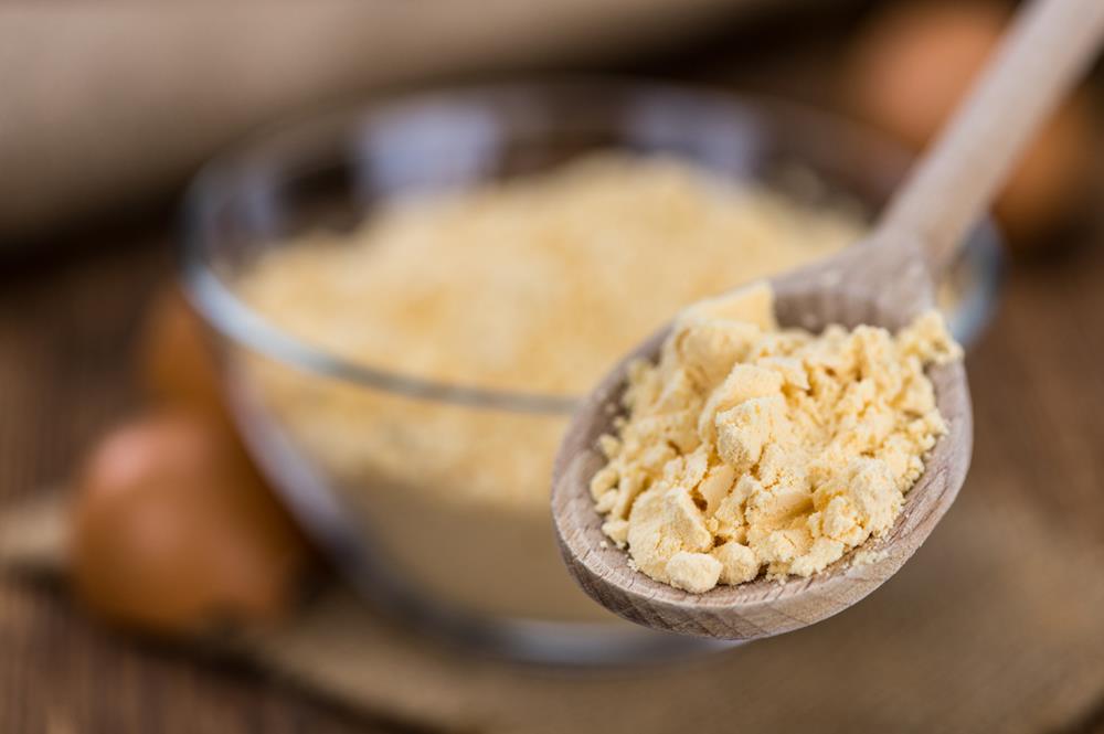 Powdered egg on a wooden spoon