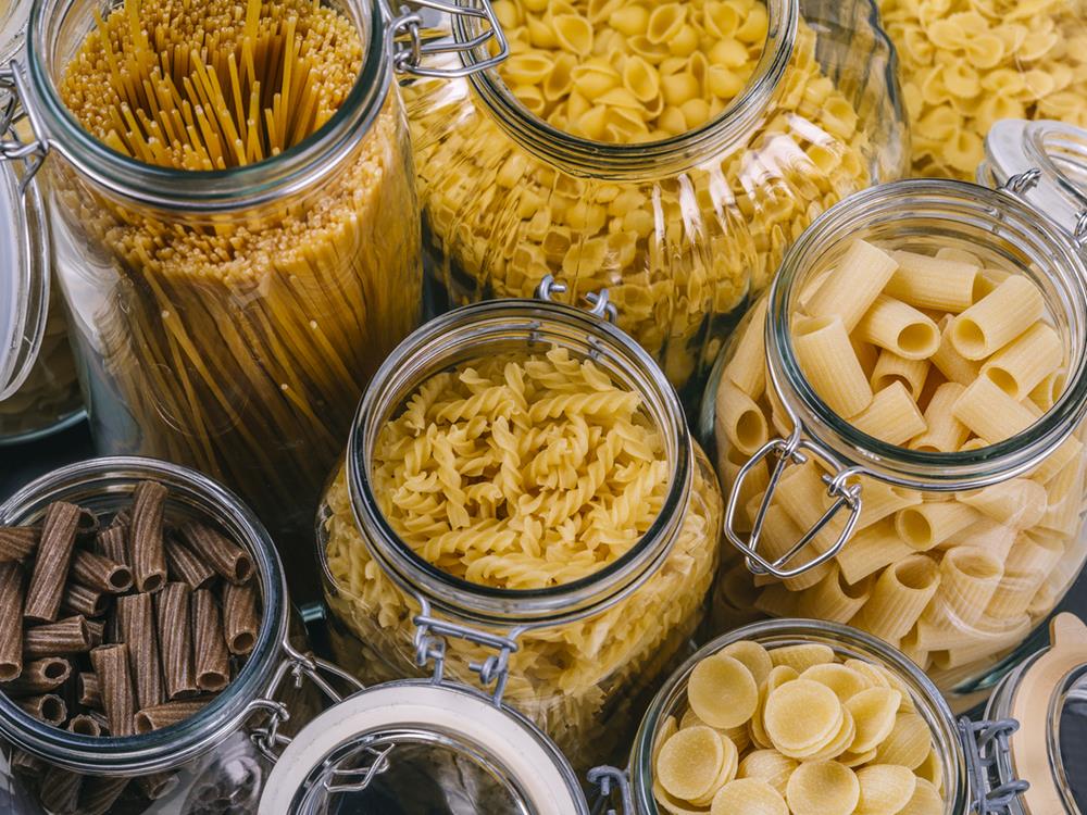 Different pasta types in large glass jars