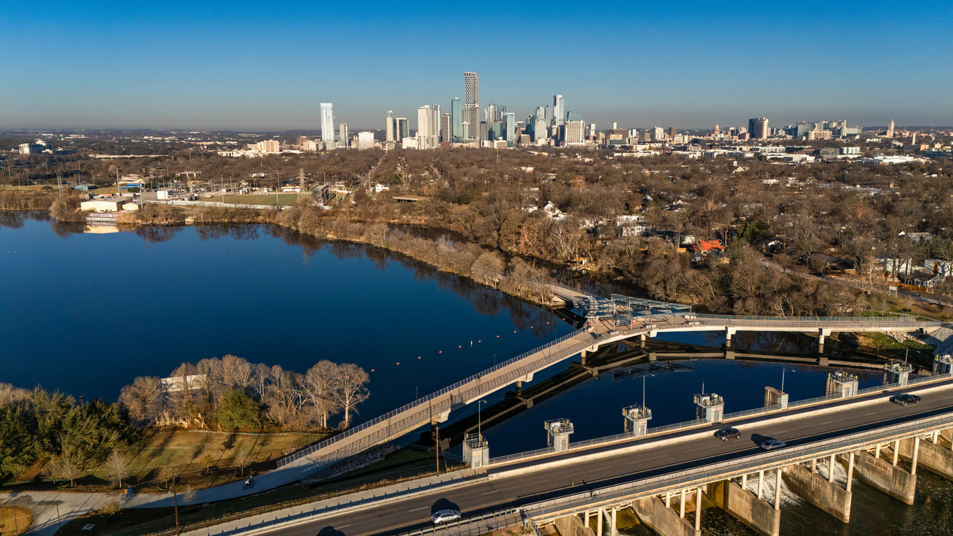 drone photograph of Longhorn Dam and the modern Wishbone Pedestrian Bridge spanning Lady Bird Lake in East Austin, Texas