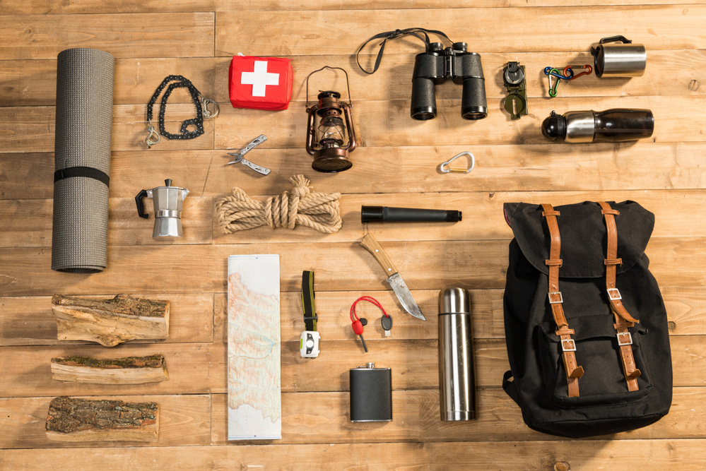 Traveler set on wooden background, flat lay
