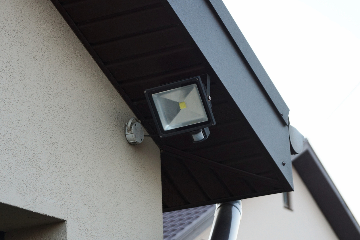 white square LED lantern on a black board on the roof
