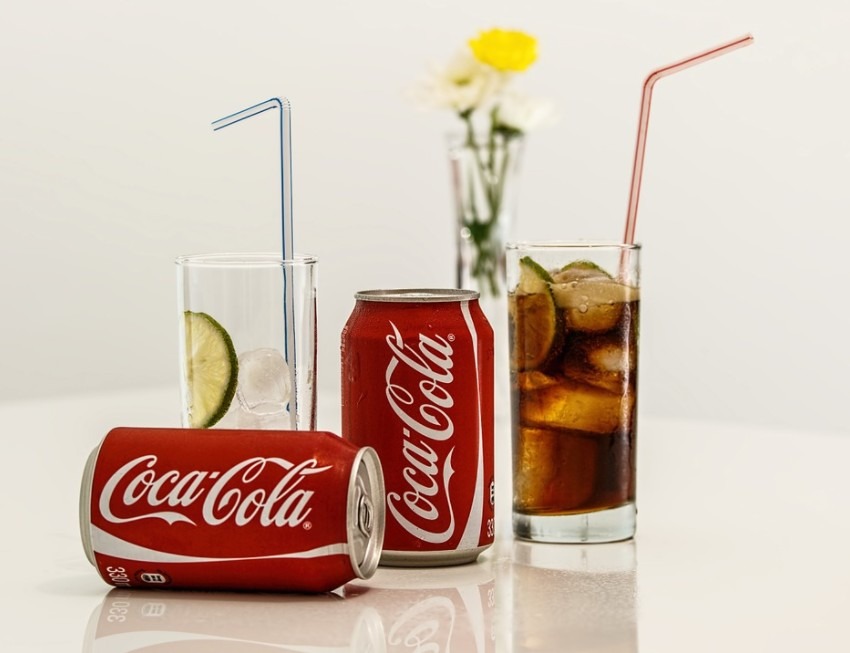 2 CocaCola can drink with Two glass of soda