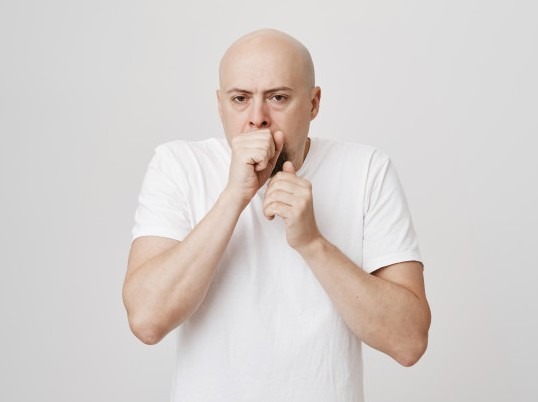 A middle-aged man choking on food