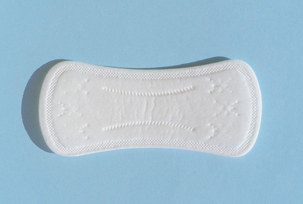 Flat lay clean pad on blue background