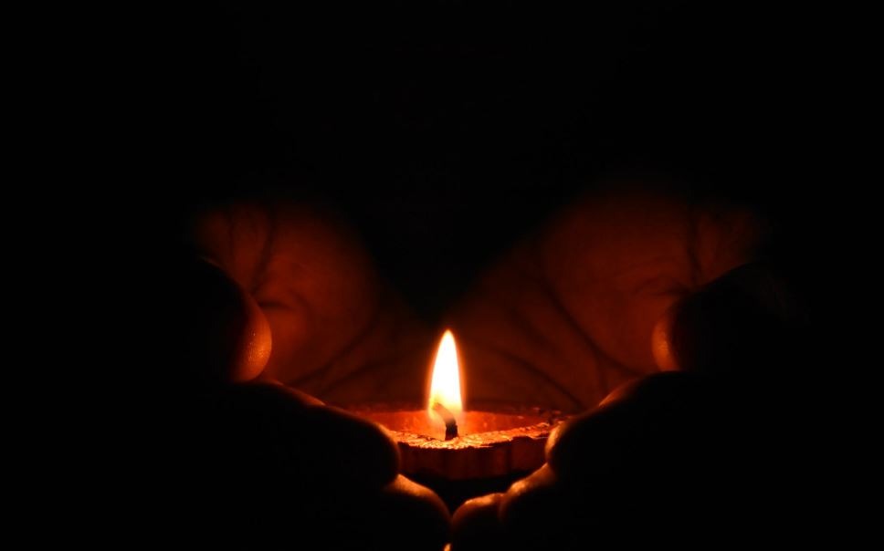 tealight-candle-on-human-palms