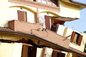 front view of a house collapsed due to earthquake