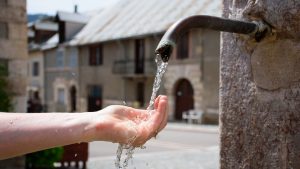water from fountain falling on a hand