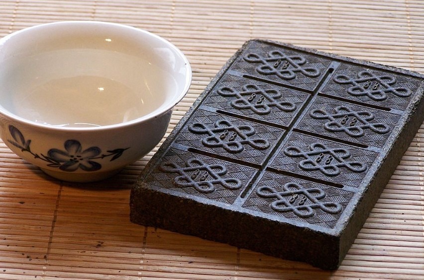 a tea brick beside a bowl