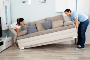man woman lifting couch