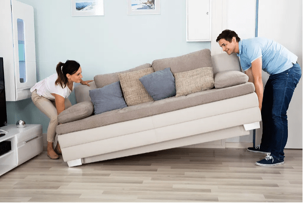 man woman lifting couch