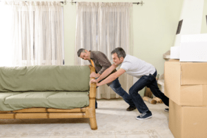 men pushing couch