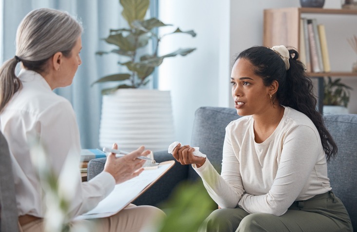 Shot of an attractive young woman sitting and talking to her psychologist during a consultation
